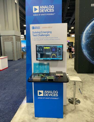 a booth image showing ADI RF products displayed with Signal Hound test equipment